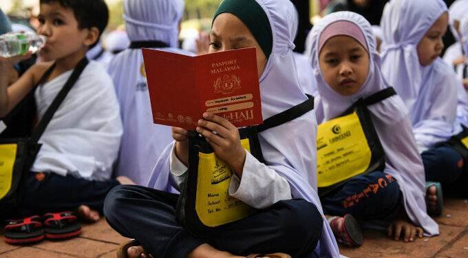 Malaysia gives each student $33 in school aid
