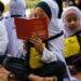 Malaysia gives each student $33 in school aid